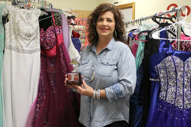 MEGAN DAVIS/MCDONALD COUNTY PRESS Susan Fickle stands amid sharp tuxes and glittering gowns in the high school counselor's office turned evening wear boutique.