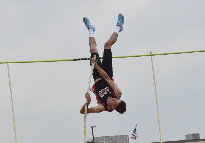 RICK PECK/SPECIAL TO MCDONALD COUNTY PRESS Zack Woods goes inverted on his way to clearing 13-3 to take second place in the pole vault at the Missouri Class 4 District 6 Track and Field Championships on May 12 at Carl Junction High School.