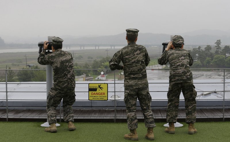South Korean marine force members look toward North's side through binoculars at the Imjingak Pavilion in Paju near the border village of Panmunjom, South Korea, Wednesday, May 16, 2018. North Korea on Wednesday canceled a high-level meeting with South Korea and threatened to scrap a historic summit next month between U.S. President Donald Trump and North Korean leader Kim Jong Un over military exercises between Seoul and Washington that Pyongyang has long claimed are invasion rehearsals. (AP Photo/Ahn Young-joon)