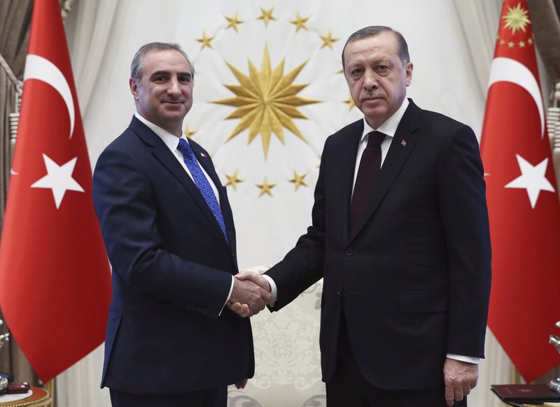 FILE - In this Dec. 5, 2016 file photo, Turkey's President Recep Tayyip Erdogan, right, and Israeli Ambassador Eitan Naeh shake hands after Naeh has presented his letter of credentials, in Ankara, Turkey. Turkey on Tuesday temporarily expelled Israel's ambassador in Ankara after he was called into the ministry, where Turkey relayed its condemnation of Israel's use of deadly force on Gaza protesters. (Presidential Press Service/Pool photo via AP, File)