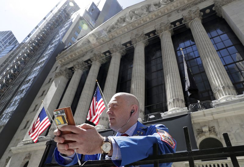 FILE- In this April 26, 2018, file photo, Vincent Pepe enjoys some fresh air outside the New York Stock Exchange where he works in the Financial District in New York.  (AP Photo/Kathy Willens, File)