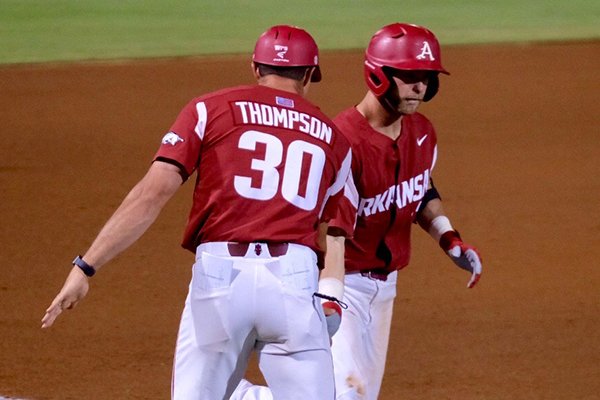 Arkansas senior designated hitter Luke Bonfield, right, is congratulated by Arkansas hitting coach Nate Thompson after Bonfield hit a home run during a game against Georgia on Thursday, May 17, 2018, in Athens, Ga. 