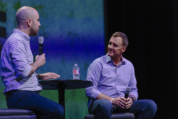 Arkansas football coach Chad Morris, right, listens while Cross Church Fayetteville pastor Nick Floyd speaks during an event Tuesday, May 15, 2018, in Fayetteville. 