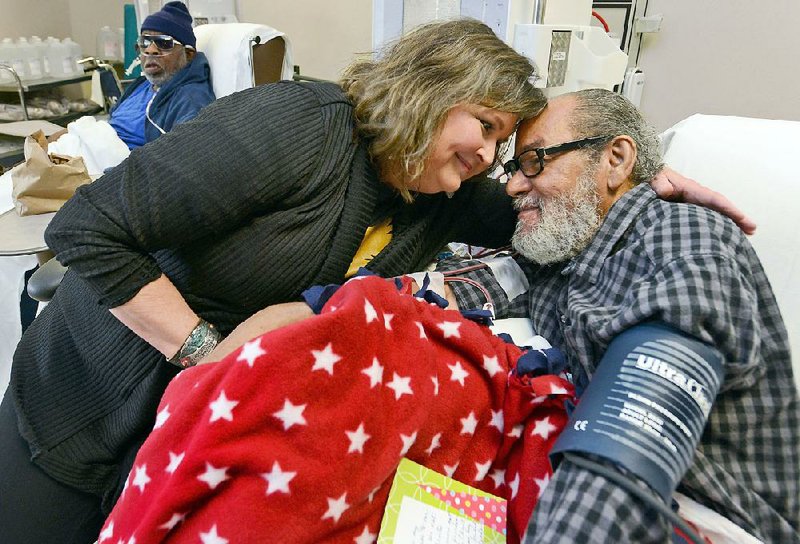 Susan Cookus comforts Army veteran Dannie Walker in the dialysis unit of John L. McClellan Memorial Veterans Hospital in Little Rock. She was named the 2016-17 Female Volunteer of the Year by the National Advisory Committee of the Department of Veterans Affairs Voluntary Services. 
