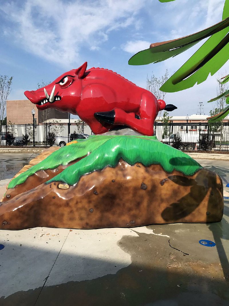 A bright red Razorback invites kids to climb aboard at Playscape. 