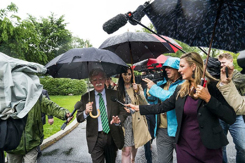 John Bolton, President Donald Trump’s national security adviser, makes his way through reporters Thursday as he arrives at the White House. Bolton’s statement about North Korea following the “Libya model” on ending its nuclear weapons program was contradicted Thursday by Trump. “The Libya model isn’t the model that we have at all when we’re thinking of North Korea,” Trump said.  
