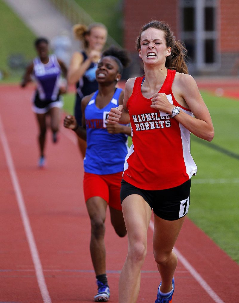 Claire Luallen (right) of Maumelle crosses the fi nish line ahead of Little Rock Parkview’s Johnaya Givens (center) in the 800-meter run Thursday at the state high school heptathlon in Cabot. Luallen, who fi nished with a time of 2 minutes, 38.31 seconds in the event, won the decathlon by 39 points over Tai’Sheka Porchia of Camden Fairview. For more photos, visit arkansasonline.com/galleries. 