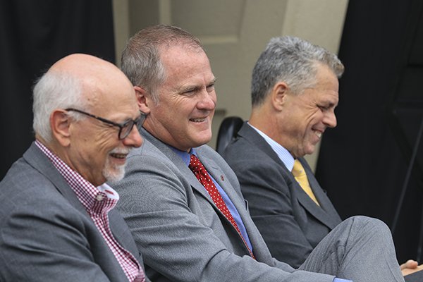 From left, University of Arkansas Chancellor Joseph Steinmetz, UA Athletics Director Hunter Yurachek and Arkansas Parks and Tourism Executive Director Kane Webb sit during a press conference Thursday, May 17, 2018, at War Memorial Stadium in Little Rock. 