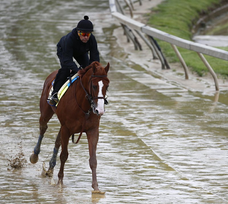 The Associated Press PREAKNESS PREP: Kentucky Derby winner Justify, with exercise rider Humberto Gomez aboard, gallops around the track Thursday at Pimlico Race Course in Baltimore in preparation for the Preakness Stakes scheduled for Saturday.
