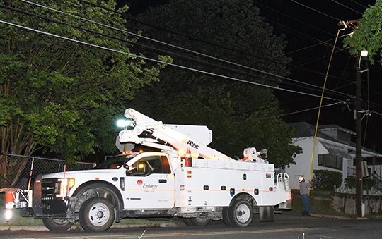 The Sentinel-Record/Grace Brown POWER RESTORED: An Entergy Arkansas Inc. employee works to restore power at the intersection of Hobson Avenue and Pearl Street at around 9:20 p.m. Wednesday. Power was restored to the area in about 30 minutes.