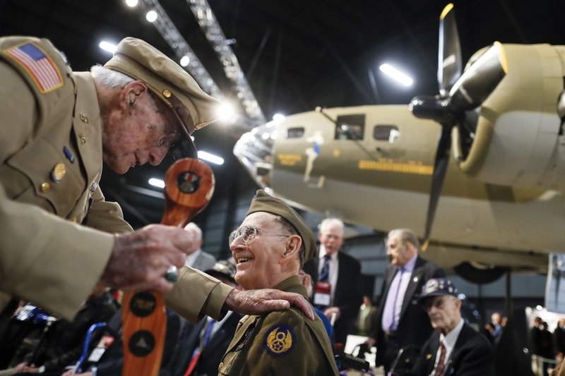 Veterans gather for a private viewing of the Memphis Belle, a Boeing B-17 "Flying Fortress," at the National Museum of the U.S. Air Force, Wednesday, May 16, 2018, in Dayton, Ohio. The World War II bomber Memphis Belle is set to go on display for the first time since getting a yearslong restoration at the museum. The B-17 "Flying Fortress" will be introduced Thursday morning as the anchor of an extensive exhibit in the Dayton-area museum's World War II gallery. (AP Photo/John Minchillo)