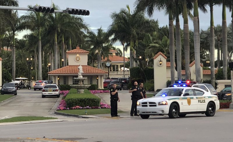 Police respond to The Trump National Doral resort after reports of a shooting inside the resort Friday, May 18, 2018 in Doral, Fla. A man shouting about Donald Trump entered the president's south Florida golf course early Friday, draped a flag over a lobby counter and exchanged fire with police before being arrested, police said. One officer received an unspecified injury, officials said. (AP Photo/Frieda Frisaro)

