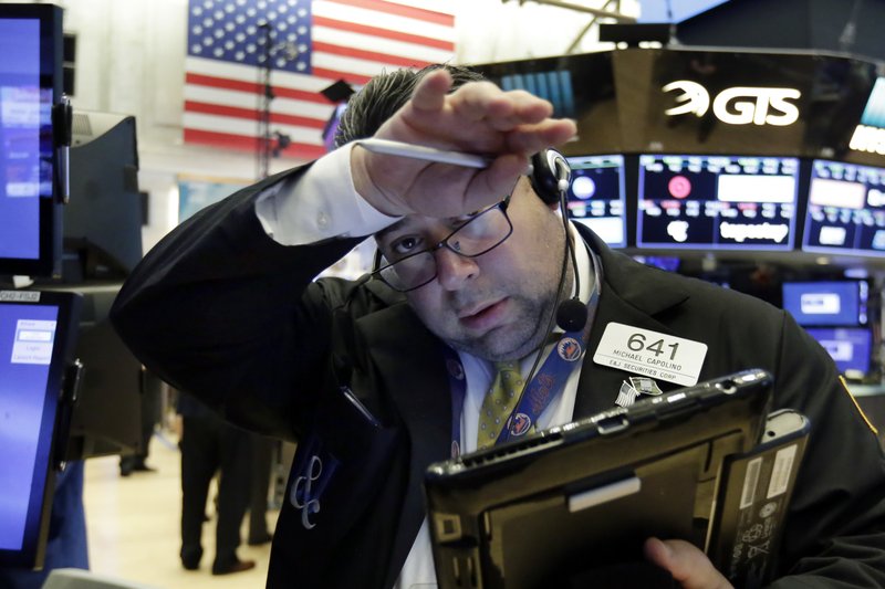 Trader Michael Capolino wipes his brow as he works on the floor of the New York Stock Exchange on Friday. The Dow Jones industrial average edged up in early trading. (AP Photo/Richard Drew)