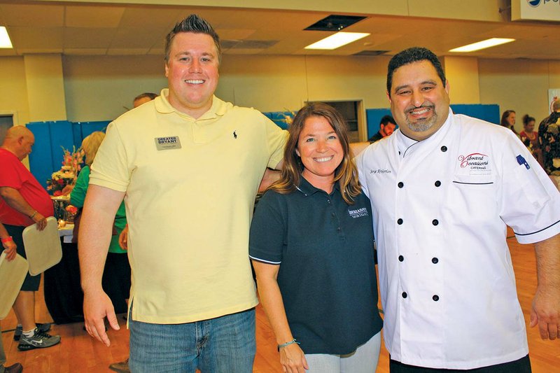 Greater Bryant Chamber of Commerce President and CEO Todd Rhoden, left, Taste of Bryant committee chairman Kim Leech and chef Serge Krikorian pose for a photo during last year’s Taste of Bryant at Bishop Park. 