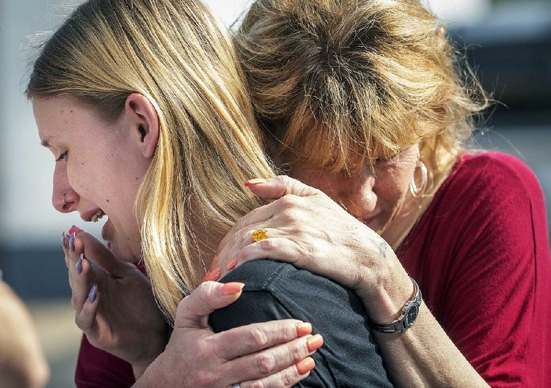 Dakota Shrader, a student at Santa Fe High School in Santa Fe, Texas, is comforted Friday by her mother, Susan Davidson, after the shooting at the school. Shrader said a friend was one of those who was shot.  