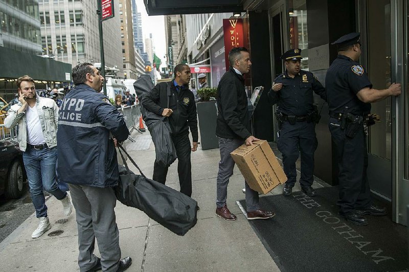 Police enter the Gotham Hotel in New York, where a woman and child fell to their deaths.  
