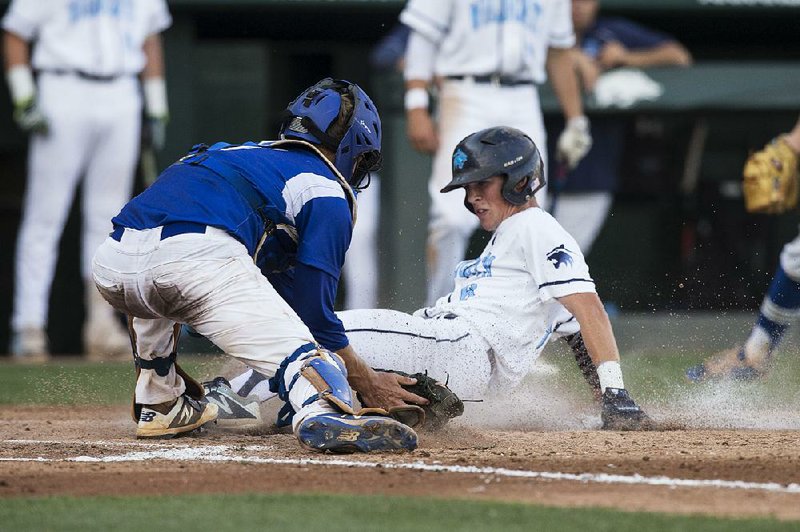 Springdale Har-Ber shortstop Mac McCroskey slides in to score ahead of a tag from Conway catcher Jack Stroth in the fifth inning of Har-Ber’s 6-0 victory over Conway in the Class 7A state championship game.  