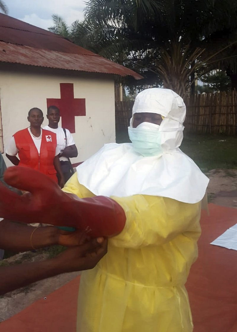 In this photo taken Monday, May 14, 2018, members of a Red Cross team don protective clothing before heading out to look for suspected victims of Ebola, in Mbandaka, Congo. Congo's Ebola outbreak has spread to Mbandaka, a crossroads city of more than 1 million people, in a troubling turn that marks one of the few times the vast, impoverished country has encountered the lethal virus in an urban area. (Karsten Voigt/International Federation of Red Cross and Red Crescent Societies via AP)