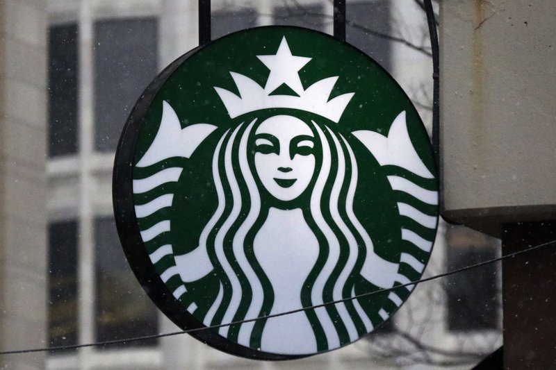 This March 14, 2017, file photo show the Starbucks logo on a shop in downtown Pittsburgh. Starbucks is announcing a new policy that allows anyone to sit in its cafes or use its restrooms, even if they don't buy anything. Company executives have said its previous policies were loose and ambiguous, leaving decisions on whether people could sit in its stores or use the restroom up to store managers. Starbucks said Saturday, May 19, 2018 it has told workers to consider anyone who walks into its stores a customer, "regardless of whether they make a purchase." (AP Photo/Gene J. Puskar, File)