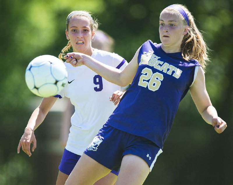 Central Arkansas Christian’s Claire Vest (9) and Berryville’s Abby Thurman (26) attempt to possess the ball during Saturday’s Class 4A girls soccer state championship match at Razorback Field in Fayetteville. CAC shut out Berryville 6-0 for its third consecutive title and eighth overall.  
