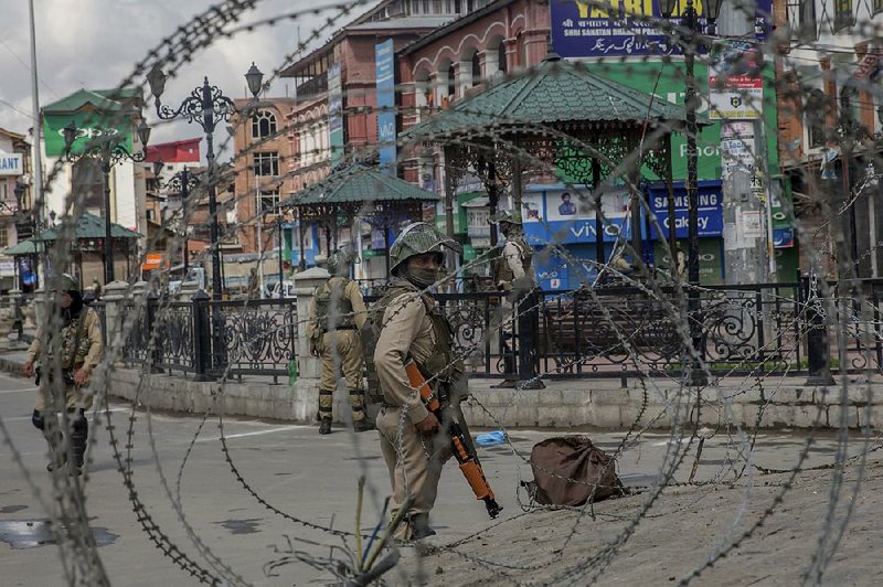 Indian paramilitary soldiers patrol the streets Saturday in Srinagar. 