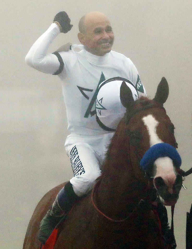 Jockey Mike Smith and Justify won Saturday’s Preakness Stakes in the fog and rain. 
