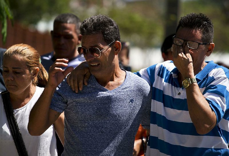 Relatives of those who died in Friday’s plane crash arrive at a morgue Saturday in Havana. 
