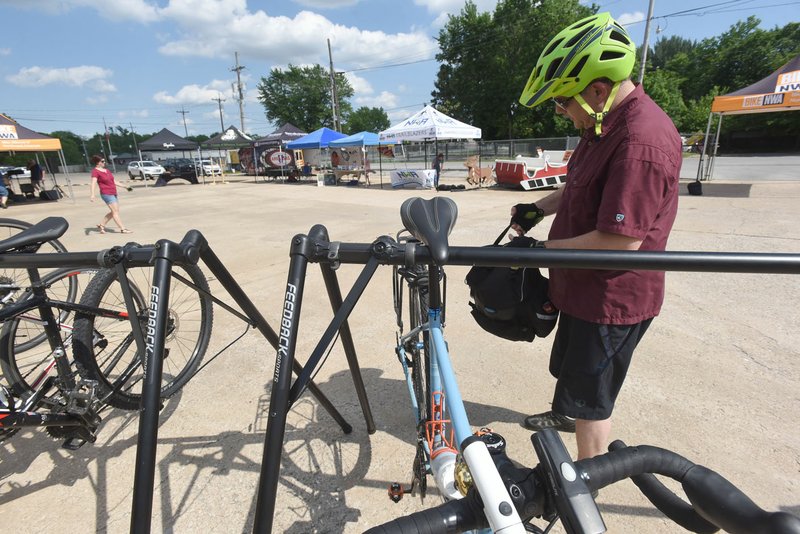 Eric Liberatore of Bella Vista parks his bike at the Ride Your Bike To Work Day party Friday at BikeNWA in Bentonville. Liberatore biked to his job on Friday.