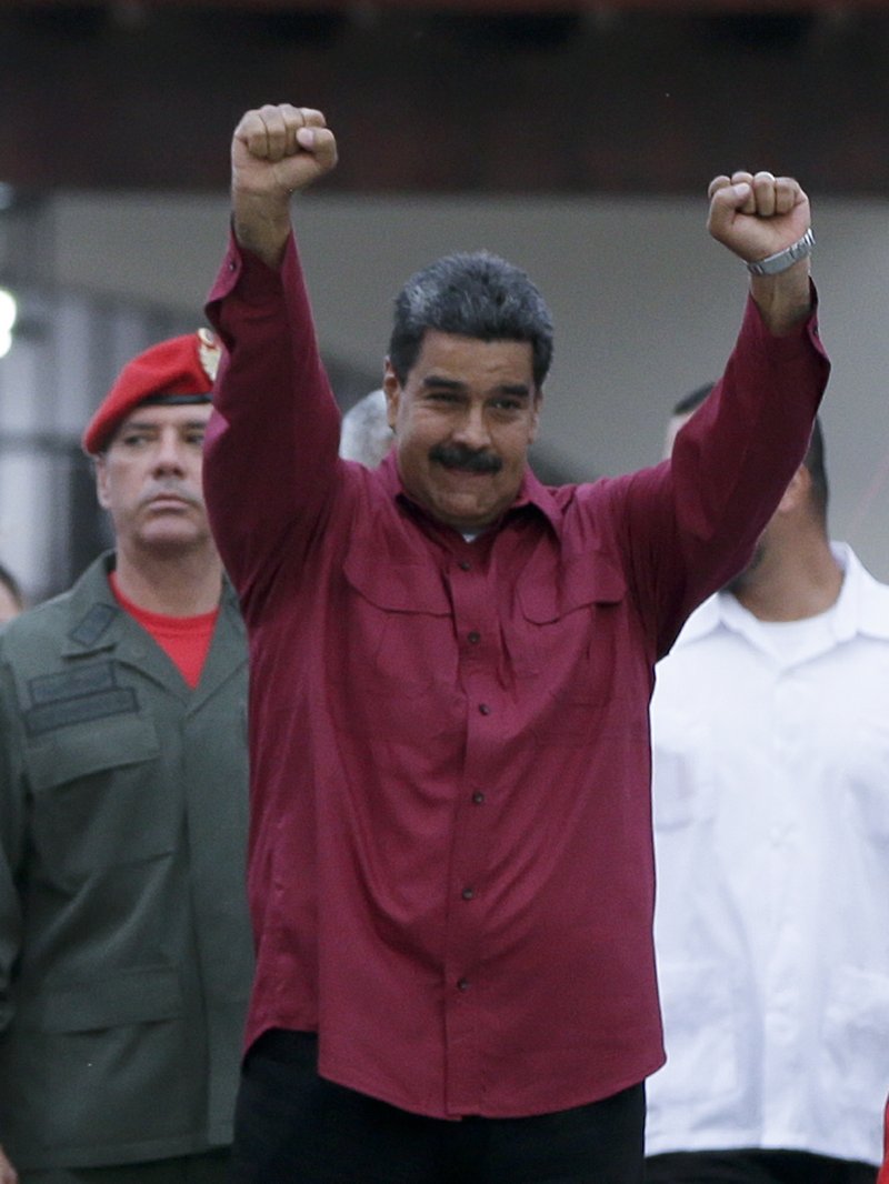 Venezuela's President Nicolas Maduro raises his fists after voting in presidential elections in Caracas, Venezuela, Sunday, May 20, 2018. Amidst hyperinflation and shortages of food and medicine Maduro is seeking a second six-year term in an election that a growing chorus of foreign governments refuse to recognize after key opponents were barred from running. (AP Photo/Ricardo Mazalan)