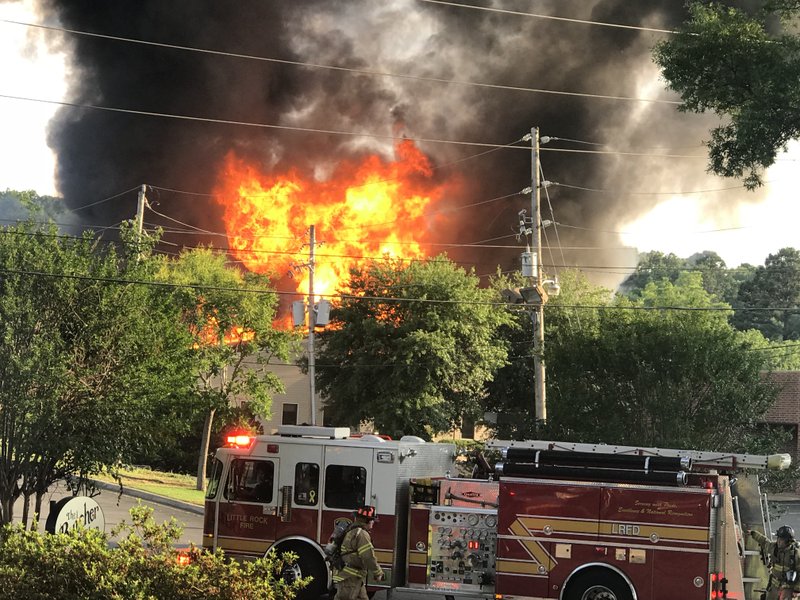 Firefighters respond to a blaze in west Little Rock on Sunday, May 20, 2018.