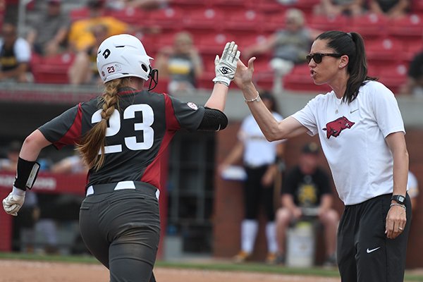 Hannah McEwen rounds third and high fives Arkansas coach Courtney Deifel following a home run in the Razorbacks' game against Wichita State Sunday May 20, 2018 during the NCAA Regional Softball Tournament at Bogle Park in Fayetteville. Arkansas won 6-4 and advanced to its first super regional.