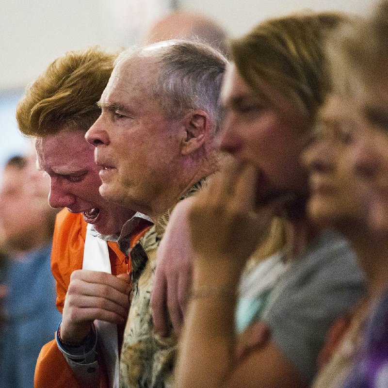 Nathan Jordan, 18, a senior at Alvin High School, sobs during a service at Arcadia First Baptist Church on Sunday, two days after a shooting that killed 10 people at Santa Fe High School in Santa Fe, Texas. 