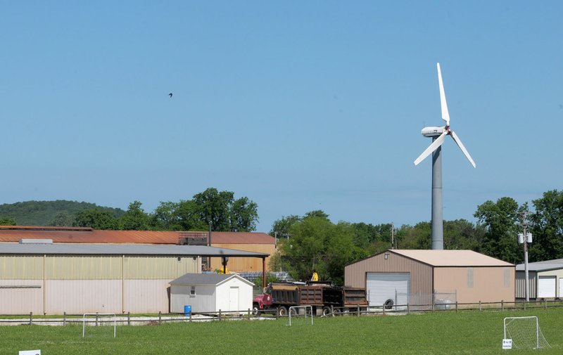 NWA Democrat-Gazette/DAVID GOTTSCHALK A wind turbine sits still Thursday, May 17, 2018, near Industrial Park Road in Prairie Grove. The solitary turbine has mot worked for several years after what the owner suspects was a lightning strike around 2010, but it spun for years before then. Arkansas is generally seen as an unsuitable place for wind energy, but some have still tried to generate power from wind.