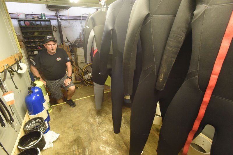Randall Fuller, assistant chief, shows Saturday tanks and wet suits in the Nob Hill Fire Department's dive team trailer.