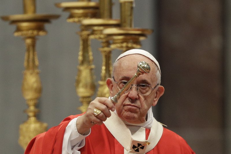 Pope Francis asperges holy water as he celebrates a Pentecost mass in St. Peter's Basilica, at the Vatican, Sunday, May 20, 2018. (AP Photo/Gregorio Borgia)

