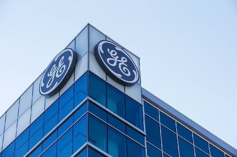 The General Electric logo is displayed at the top of the company’s Global Operations Center in downtown Cincinnati. General Electric will tie its train engine division to railroad equipment maker Wabtec in a deal worth about $11 billion. 
