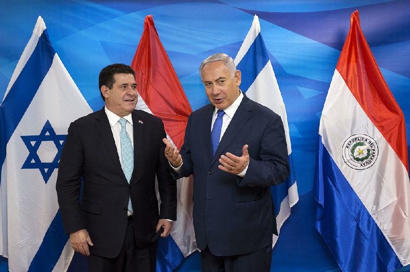 Paraguayan President Horacio Cartes (left) appears with Israeli Prime Minister Benjamin Netanyahu on Monday to open Paraguay’s new embassy in Jerusalem. 
