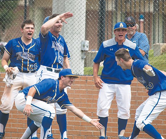 CLUTCH HIT: Redshirt sophomore catcher Zach Muldoon, left, and his Southern Arkansas teammates greet senior first baseman Cortland McPherson, right, after his two-run home run put the Muleriders ahead 5-3 in the eighth inning on Monday against Augustana in the Magnolia Regional. The 5-3 win forced a deciding game Monday evening for a trip to the 2018 NCAA Division II Baseball Championship. Photo by Brenna Johnson, courtesy of Southern Arkansas Athletics Communications.