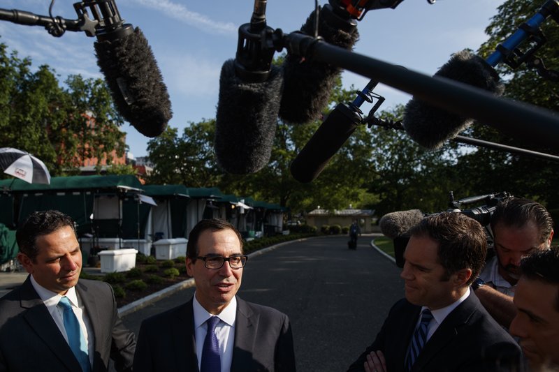 Treasury Secretary Steve Mnuchin talks with reporters about trade with China outside of the White House, Monday, May 21, 2018, in Washington. (AP Photo/Evan Vucci)