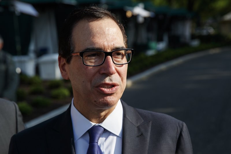 Treasury Secretary Steve Mnuchin talks with reporters about trade with China outside of the White House, Monday, May 21, 2018, in Washington. (AP Photo/Evan Vucci)
