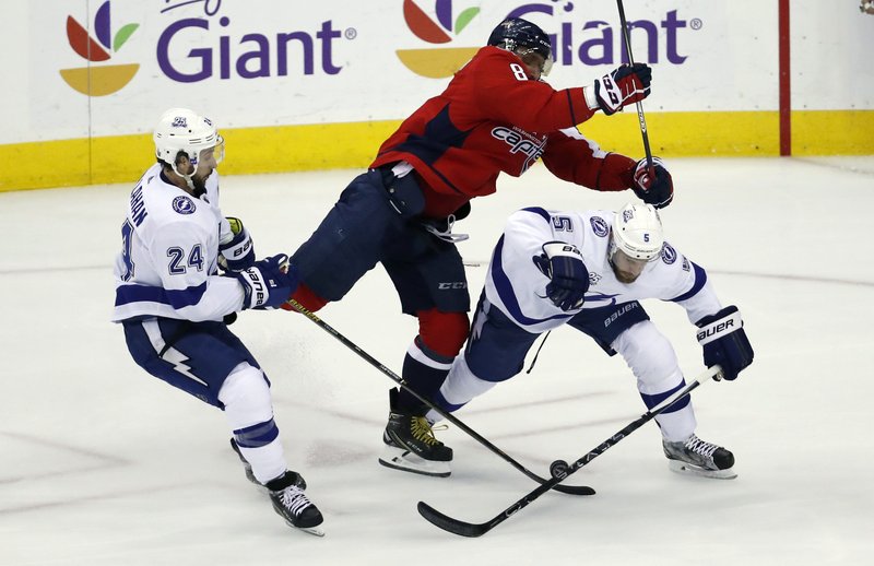 Washington Capitals left wing Alex Ovechkin (8), from Russia, hits Tampa Bay Lightning defenseman Dan Girardi (5) with Lightning right wing Ryan Callahan (24) nearby during the first period of Game 6 of the NHL Eastern Conference finals hockey playoff series Monday, May 21, 2018, in Washington. (AP Photo/Alex Brandon)
