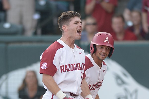 Arkansas second baseman Carson Shaddy (20) celebrates with center fielder Dominic Fletcher after hitting a 3-run home run Friday, May 11, 2018, during the first inning against Texas A&M at Baum Stadium in Fayetteville.