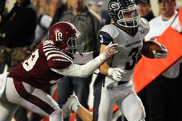 Pine Bluff defender Rod Stinson Jr. (18) tackles Greenwood receiver Peyton Holt during the Class 6A state championship game on Friday, Dec. 1, 2017, in Little Rock. 