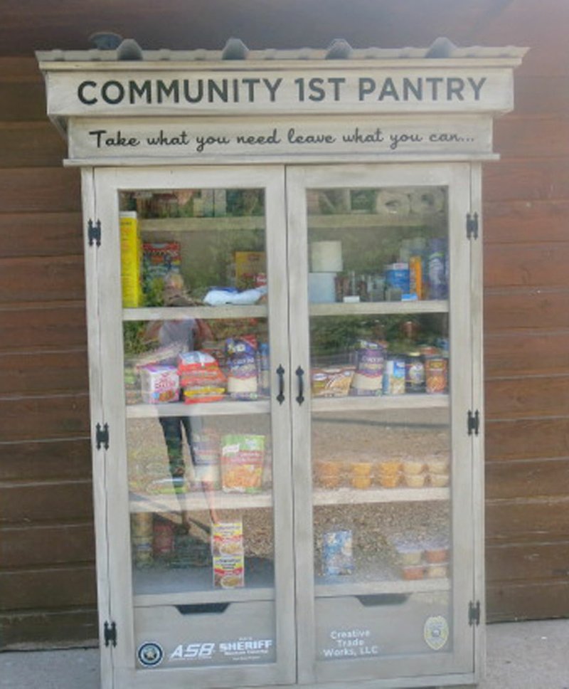 Westside Eagle Observer/SUSAN HOLLAND A Community 1st Food Pantry, established jointly by the Gravette Police Department and the Benton County Sheriff's Office, is open at the Thairapy Hair Salon on Highway 59 just south of Hillcrest Cemetery in Gravette. The pantry, lettered with the slogan&quot;Take what you need, leave what you can,&quot; is stocked with canned and dry foods and personal hygiene items.