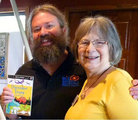 Submitted photo DINOSAUR PRESENTATION: Doug Herbert, left, is shown with Diana Whitlow, Rotary Club of North Garland County/Scenic 7 program chair for the month. The book "Dinosaur Trivia" will be presented to a local school library in honor of Herbert's presentation.