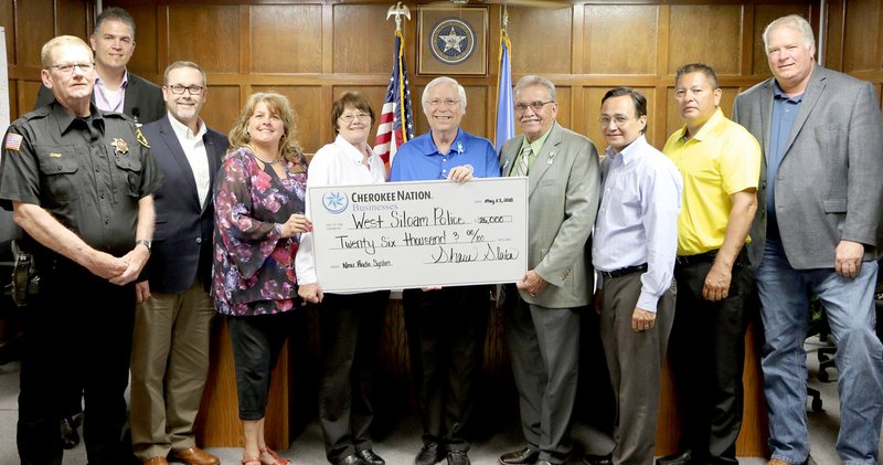 Photo submitted Cherokee Nation Businesses contributed $26,000 to the West Siloam Springs (Okla.) Police Department to help replace the department's outdated communication system. Pictured, from left, are Larry Barnett, West Siloam Springs police chief; Tony Nagy, general manager of Cherokee Casino &amp; Hotel West Siloam Springs; Don Childers, VP of surveillance and loss prevention at CNE; Kathy Osbourn, West Siloam Springs town manager; Elaine Carr, West Siloam Springs Mayor; Bill John Baker, Cherokee Nation principal chief; S. Joe Crittenden, deputy chief; Chuck Hoskin Jr.; secretary of state; Mike Shambaugh, tribal councilor; and Shawn Slaton, CEO of Cherokee Nation Businesses.