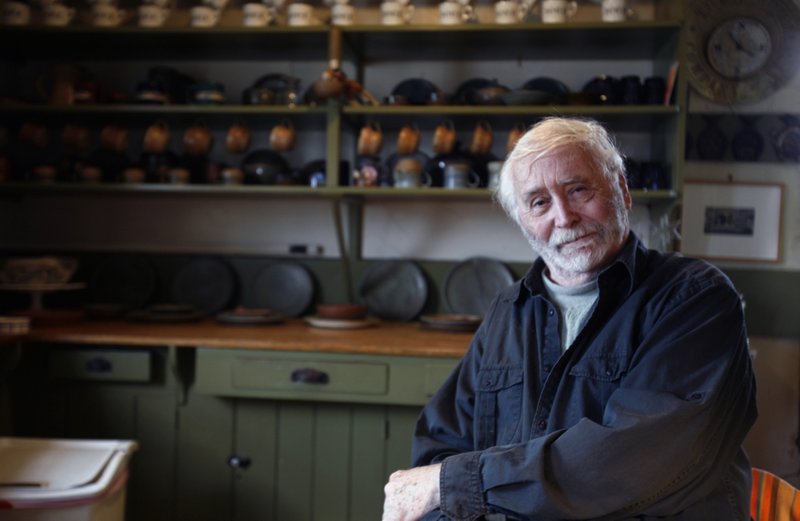 FILE - In this May 14, 2009 file photo, pop artist Robert Indiana, 80, poses in the kitchen at his home on Vinalhaven Island, Maine. Indiana, best known for his 1960s LOVE series, died from respiratory failure Saturday, May 19, 2018, at his home in Maine, Indiana's attorney said. He was 89. (AP Photo/Pat Wellenbach, File)