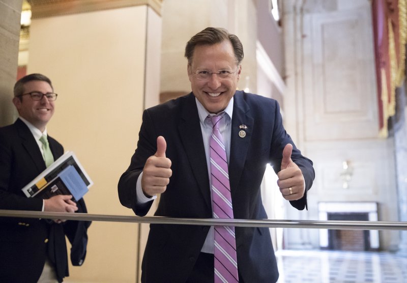 Rep. Dave Brat, R-Va., a member of the conservative House Freedom Caucus, smiles before the vote on the House farm bill which failed to pass, at the Capitol in Washington, Friday, May 18, 2018. (AP Photo/J. Scott Applewhite)