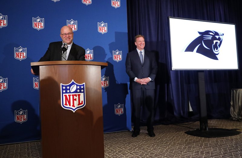 David Tepper, left, speaks as NFL commissioner Roger Goodall looks on during a news conference where he was introduced as the new owner of the Carolina Panthers at the NFL owners spring meeting Tuesday, May 22, 2018, in Atlanta. (AP Photo/John Bazemore)