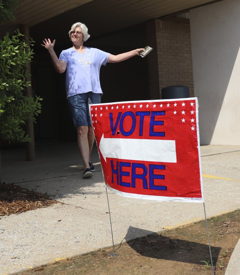 Cindy Benton celebrates after voting in the Arkansas primary election on Tuesday in Little Rock. The Democratic and Republican parties held elections Tuesday, while all registered voters were allowed to vote in judicial elections. (AP Photo/Kelly P. Kissel)
